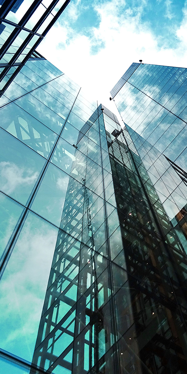 glass-faced office building in downtown environment